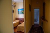 a small room with two beds and a hallway at Hotel Villa Ruscello in Baveno