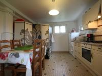 a kitchen with a table and chairs and a refrigerator at Gîte Champosoult, 5 pièces, 6 personnes - FR-1-497-27 in Champosoult