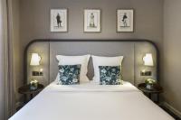 a bedroom with a large bed with two night stands at Warwick Reine Astrid - Lyon in Lyon