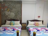 two beds with hello kitty pillows in a room at Zhong Shan 330 in Hualien City