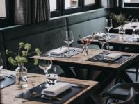 einen Tisch in einem Restaurant mit Weingläsern und Servietten in der Unterkunft VAYA Zillertal in Aschau