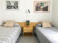 A bed or beds in a room at ROC MAR 4 3A - Apartamento cerca del centro y de la playa - terraza con vistas al mar y al puerto