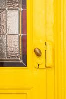 a yellow door with a door knob and a window at Le Studio Gab&#39;s - Coup de coeur déco tout confort in Caluire-et-Cuire