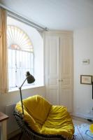 a yellow chair in a room with a window at Le Studio Gab&#39;s - Coup de coeur déco tout confort in Caluire-et-Cuire