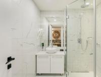 a white bathroom with a sink and a shower at Original Boutique Hotel in Tbilisi City