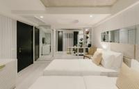 a bedroom with a white bed and a living room at Original Boutique Hotel in Tbilisi City