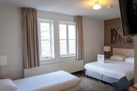 Postel nebo postele na pokoji v ubytování Fletcher Kloosterhotel Willibrordhaeghe