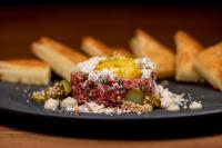a plate of food on a table with bread at Pendry Chicago in Chicago