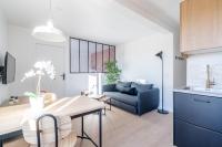 a kitchen and living room with a table and a couch at Welcome perche ! Appartements 3 étoiles à NOGENT le Rotrou in Nogent-le-Rotrou