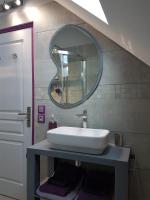 a bathroom with a white sink and a mirror at Gîte Les Nymphéas in Épeigné-les-Bois