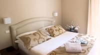 Łóżko lub łóżka w pokoju w obiekcie Hotel Carla