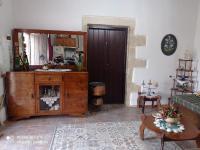 a living room with a wooden cabinet and a mirror at TRADITIONAL HOUSE MARIA in Azoyirás