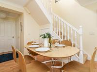 a dining room with a table and chairs at Pugwash Cottage in Falmouth