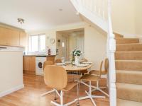 a kitchen and dining room with a table and chairs at Pugwash Cottage in Falmouth