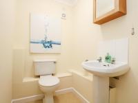 a bathroom with a toilet and a sink at Pugwash Cottage in Falmouth