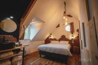 a bedroom with a large bed in a attic at Le Saltimbanque - Auberge du Moulin in Eaucourt-sur-Somme