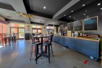 a restaurant with a bar with stools at a counter at The Gonzo Inn in Moab