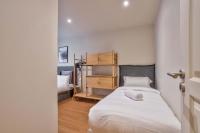 a small bedroom with a bed and a shelf at 02 - Urban Exclusive in Montorgueil in Paris