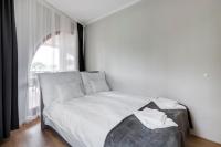 A bed or beds in a room at Fonyód Beach Apartment