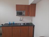 a kitchen with a sink and a microwave at Wanted Šabac apartman in Šabac