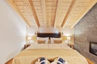a bedroom with a large bed with two lamps at Grand Hotel Zermatterhof in Zermatt