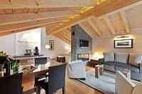 a living room with a couch and a fireplace at Grand Hotel Zermatterhof in Zermatt