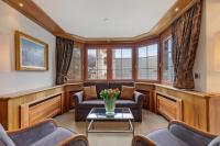 a living room with a couch and a table at Grand Hotel Zermatterhof in Zermatt