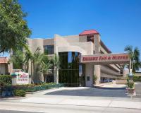 a building with a sign that reads disaster inn and suites at Anaheim Desert Inn & Suites in Anaheim