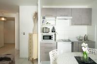 a small kitchen with a table and a microwave at Le Casper - Charmant appartement au calme proche centre-ville in Lyon