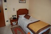 A bed or beds in a room at Grand Hotel Moroni