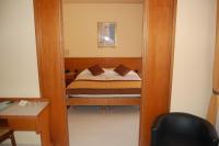 A bed or beds in a room at Grand Hotel Moroni