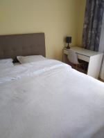 a bedroom with a white bed and a desk at chez Myla chambre avec tv écran plat et salle de bain privative in Bourges