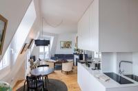 a kitchen and living room with a table and chairs at MaisondesChaumes-Paris in Paris