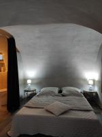 a bedroom with a large bed with two lamps at PARFUMU DI MACHJA in Santa-Lucia-di-Mercurio