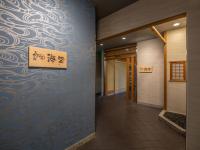 a hallway with a blue wall with a sign on it at ART HOTEL Miyazaki Sky Tower in Miyazaki