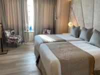 A bed or beds in a room at Nivia Born Boutique Hotel