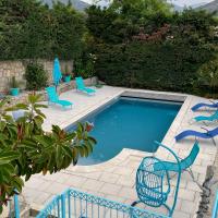 a swimming pool with blue chairs and a table at Villa Turquoise Sagone in Sagone