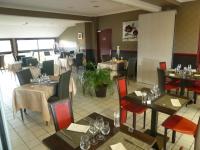 Un comedor con mesas y sillas en un restaurante. en Hotel Beau Rivage, en Le Vivier-sur-Mer