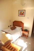 A bed or beds in a room at Grand Hotel Moroni