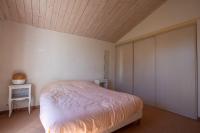 a bedroom with a bed and a wooden ceiling at Nature et decouverte a Brem sur Mer in Brem-sur-Mer