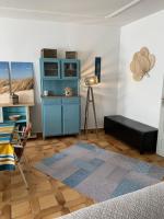 a living room with a blue cabinet and a table at Appartement la corde a linge Gruissan village avec terrasses in Gruissan