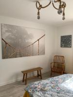 a bedroom with a bed and a bridge painting on the wall at Appartement la corde a linge Gruissan village avec terrasses in Gruissan