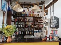 a bar with a bunch of bottles on the wall at Pony's Lodge B&B in Caraz
