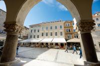 an archway in a city with people walking in the street at Heritage hotel Santa Lucia in Split