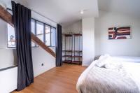 a bedroom with a bed and a large window at 135 - Urban Five Star Apartment in Center of Paris in Paris