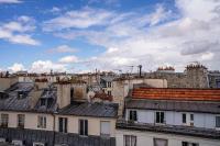 a view of roofs of buildings in a city at 135 - Urban Five Star Apartment in Center of Paris in Paris