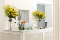 a mirror with vases of flowers on a counter at Heritage hotel Santa Lucia in Split