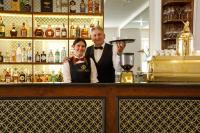 a man and a woman standing behind a bar at Heritage hotel Santa Lucia in Split