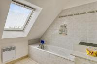 a bathroom with a white tub and a window at Maison de 4 chambres avec jardin clos a Nevez a 1 km de la plage in Névez