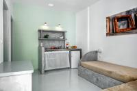 a living room with a couch and a kitchen at Coralli Seaside Resort in Livadakia